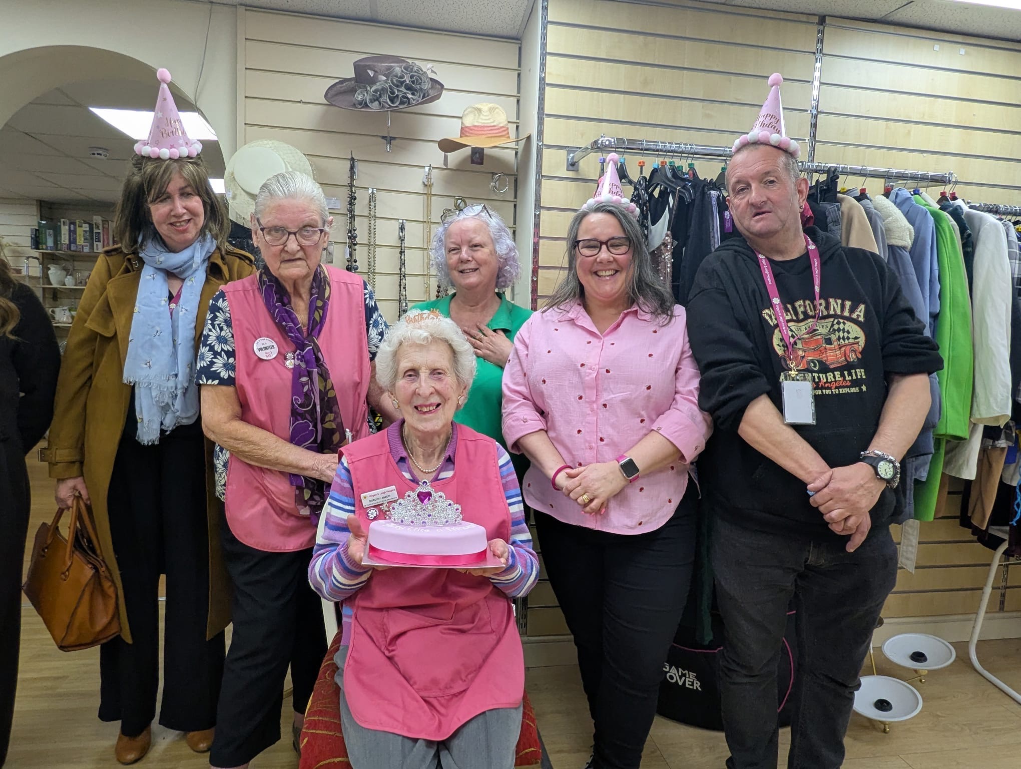Dorothy celebrates with her colleagues at the Bradshawgate hospice shop